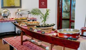 a buffet with bowls of food on a table at Victoria XiengThong Palace in Luang Prabang