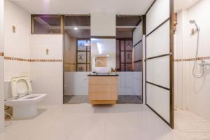 a bathroom with a toilet and a sink at Pasadena Lodge in Pattaya Central +71 photos