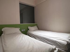 Voodi või voodid majutusasutuse 珀依旅馆 Pop E INN toas