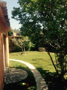 a view of a yard with a house and a tree at Chez Calou in Mane +5 photos
