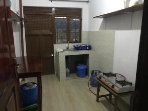 a kitchen with a fireplace in the middle of a room at BIMS Vacation Rental in Fort Portal