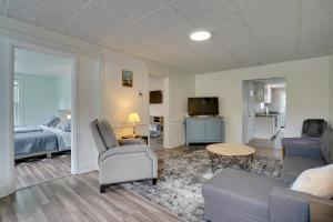 a living room with a couch and a tv at Upstate New York Vacation Rental with Hot Tub! in Kirkville