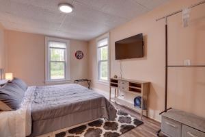 a bedroom with a bed and a flat screen tv at Upstate New York Vacation Rental with Hot Tub! in Kirkville