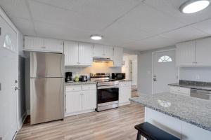 an empty kitchen with white cabinets and appliances at Upstate New York Vacation Rental with Hot Tub! in Kirkville