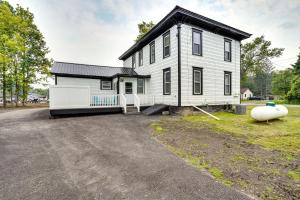 a large white house with a large driveway at Upstate New York Vacation Rental with Hot Tub! in Kirkville