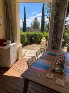 a dining table with a view of a patio at Village Pierre et vacances Cap Estérel centre FH007 jardin privatif clôturé , vue mer in Agay - Saint Raphael