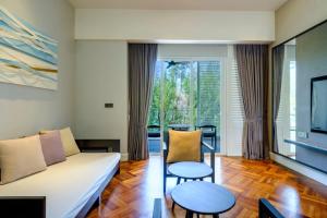 a living room with a couch and a table at Lone Pine, Penang, a Tribute Portfolio Resort in Batu Ferringhi