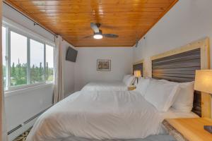 a bedroom with two beds and a ceiling fan at Highliner Hotel - Deluxe Double Queen with Mountain View in Anchorage