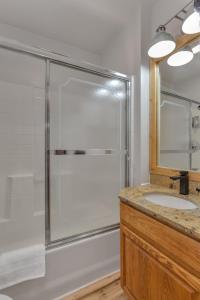 a bathroom with a shower and a sink at Highliner Hotel - King Rooms with City & Park Views in Anchorage