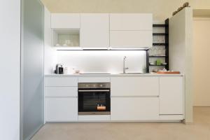 a kitchen with white cabinets and an oven at 42° parallelo in Termoli