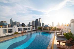 una piscina en la azotea de un edificio con vistas al perfil urbano en Zenith Sukhumvit Hotel - SHA Extra Plus, en Bangkok