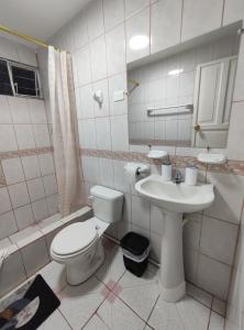 a white bathroom with a toilet and a sink at "Apartamento Blanco" en Centro de Baños in Baños
