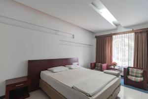 Tempat tidur dalam kamar di Istana Hotel Bandung Mitra RedDoorz