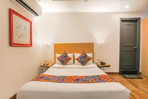 a bedroom with a large bed in a room at FabExpress PP Residency in New Delhi +23 photos