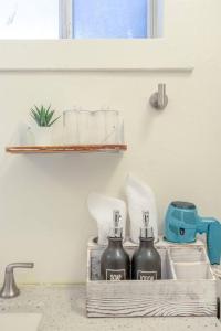 a kitchen sink with two bottles on a shelf at Modern Apt near all conveniences in Oakland