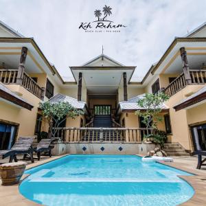 a villa with a swimming pool in front of a house at Haadson Resort & Koh Raham in Haad Son