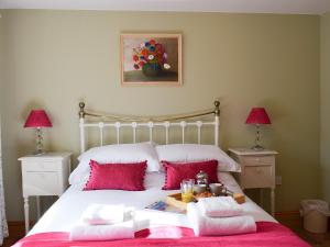 a bed with red pillows and a tray of food on it at Seventh Heaven in Bagby