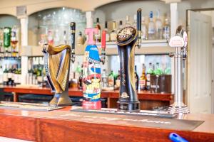 a bar with two trophies on top of a counter at The Morar Hotel in Morar