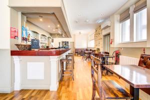 a bar in a restaurant with tables and chairs at The Morar Hotel in Morar