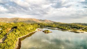 an aerial view of a body of water with mountains at The Morar Hotel in Morar