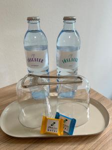 two bottles of water sitting on a plate at Office Base Bad Vöslau MOTEL in Bad Vöslau