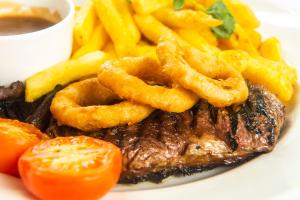 a plate of food with steak and french fries at The Morar Hotel in Morar
