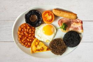 a plate of breakfast food with eggs beans and toast at The Morar Hotel in Morar