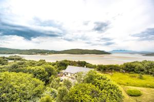 an aerial view of a house next to a body of water at The Morar Hotel in Morar