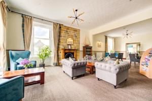 a living room with couches and a fireplace at The Morar Hotel in Morar