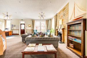 a living room with a couch and a table at The Morar Hotel in Morar