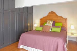 a bedroom with a large bed with green pillows at Hip Casa Beatles in downtown Gated Parking in Ensenada