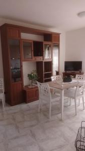 une salle à manger avec une table et des chaises blanches dans l'établissement Casetta Cavour, à Pantelleria