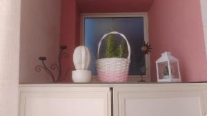 a shelf with a potted plant on top of a cabinet at Casetta Cavour in Pantelleria