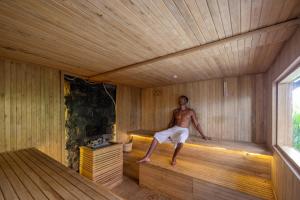 a man is sitting in a sauna at Hideaway Villas Candy-Ubud by Kanaan Hospitality in Ubud +126 photos