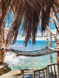 a hammock on the beach near the ocean at Haadson Resort & Koh Raham in Haad Son