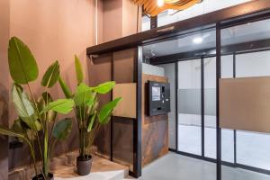 a glass door with plants in a room at NALU Valencia Boutique Rooms in Valencia