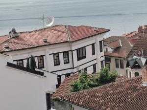 a white house with red roofs and the ocean at Villa Sv Sofija Old Town in Ohrid
