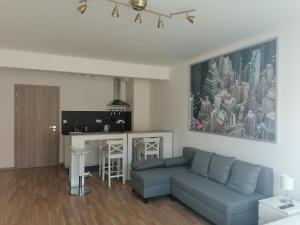 a living room with a couch and a kitchen at Brand new two room apartment #64 in Elite Rezidence with free secure parking in Prague