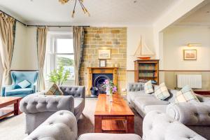 a living room with couches and a fireplace at The Morar Hotel in Morar
