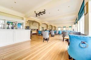 a waiting room with chairs and a barber shop at The Morar Hotel in Morar