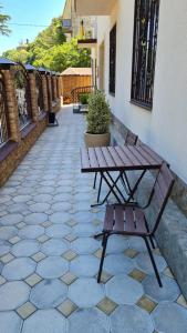 a bench and a table on a patio at Guest House Gorny Ruchei in Gagra