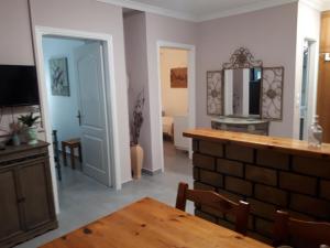 a dining room with a table and a mirror at Garneli Apartments in Kalami