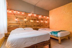 two beds in a room with lights on the wall at Casa Vacacional Temixco in Temixco