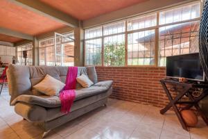 a living room with a couch and a flat screen tv at Casa Vacacional Temixco in Temixco