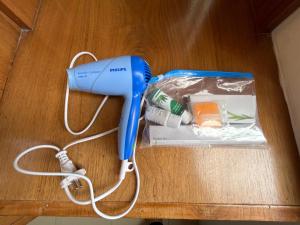 a blue blow dryer sitting on top of a table at Nature Palace Farmstay in She