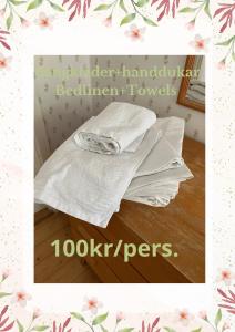 una pila de toallas blancas sentadas en una mesa en Karaby Gård, Country Living, en Kristinehamn