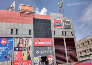 a building with advertisements on the side of it at Hotel Sasya Pride in Kurnool