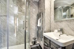 a bathroom with a sink and a shower at The Morar Hotel in Morar