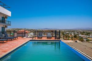 a swimming pool on the roof of a house with a view at Morgan Residences 508A in Cabo San Lucas