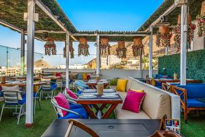 a patio with tables and chairs on a roof at Morgan Residences 508A in Cabo San Lucas